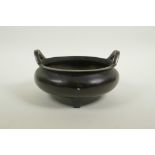 A Chinese bronze censer on tripod supports with phoenix eye handles, impressed seal mark to base, 7"