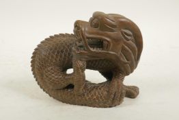 A Chinese carved hardwood dragon, 7" wide