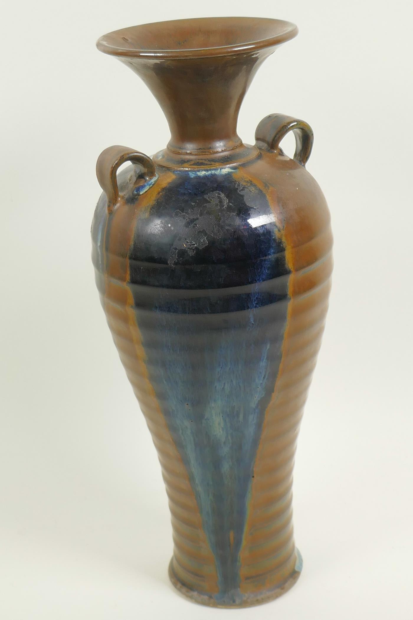 A Chinese stoneware baluster vase with rib formed body and two loop handles, drip glazed in brown - Image 2 of 4