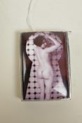A white metal vesta case stamped 800, set with a cold enamel plaque depicting a female nude, 2" long