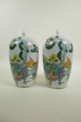 A pair of Chinese famille verte porcelain jar and covers decorated with women, children and a