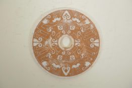 A Chinese hardstone pi disc with archaic style decoration, 8" diameter