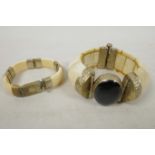 Two Oriental bone and white metal bangles, largest 2½" diameter