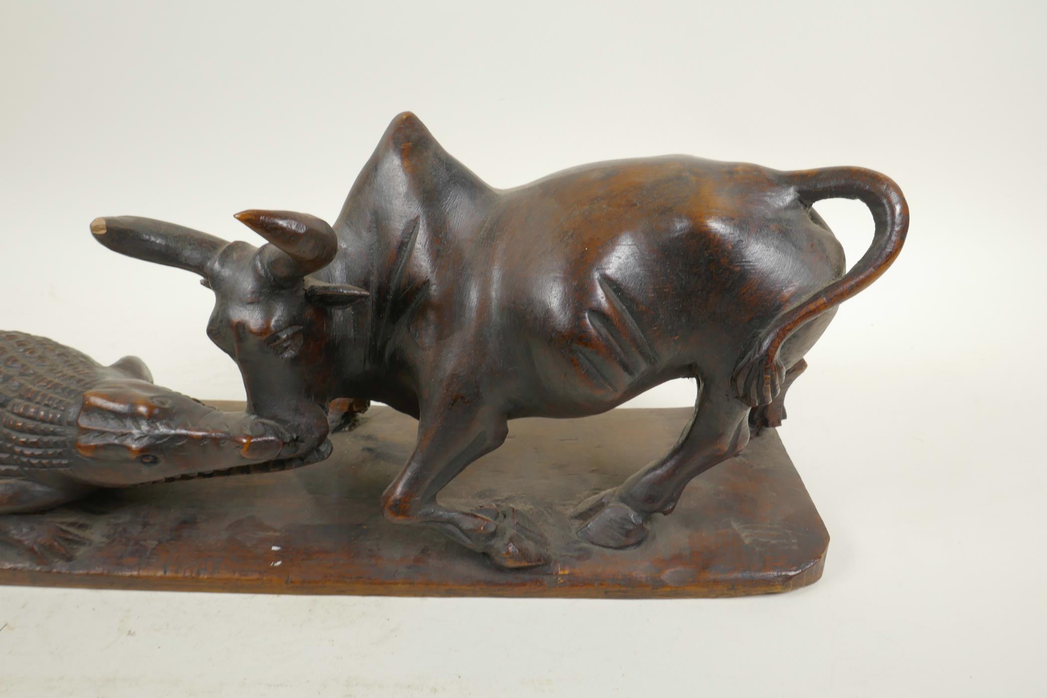 An African carved hardwood figure group decorated with a crocodile attacking a buffalo, 20½" long, - Image 4 of 6