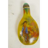 A Peking yellow glass snuff bottle, decorated with women and children, four character mark to