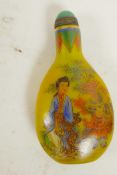 A Peking yellow glass snuff bottle, decorated with women and children, four character mark to