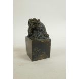 A Chinese filled bronze seal, the top surmount in the form of a longgui (dragon turtle), 2" x 2", 4"
