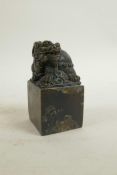 A Chinese filled bronze seal, the top surmount in the form of a longgui (dragon turtle), 2" x 2", 4"