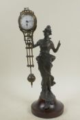 A bronze mystery clock cast in the form of an Art Nouveau lady, 11½" high