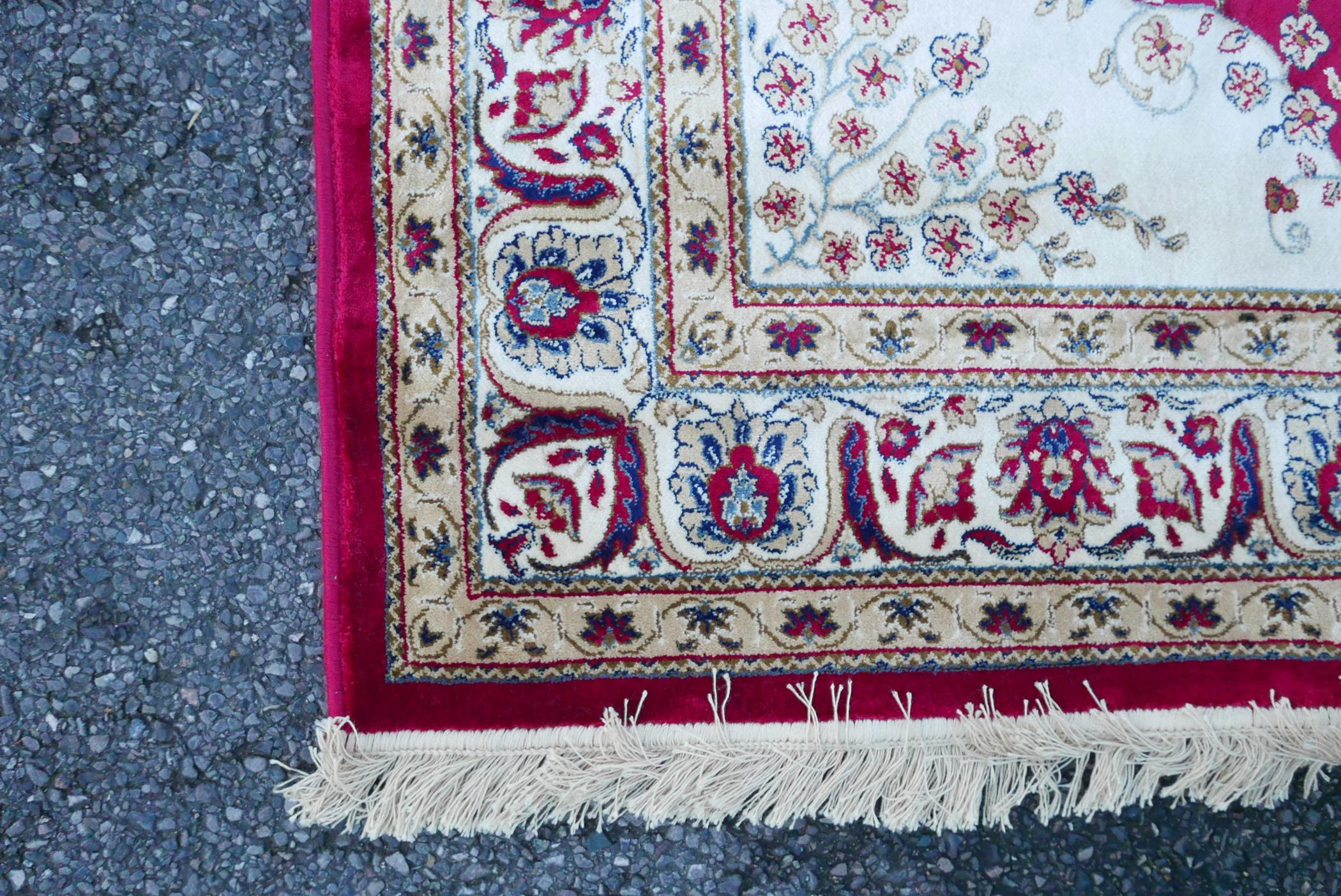 A Kashmiri red ground rug with an unique floral medallion design, 61½" x 91" - Image 4 of 5
