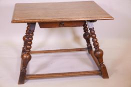 A stately mid C19th German centre table in oak, on turned and splayed legs, with flat and wide