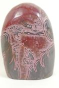 A Chinese soapstone seal with carved decoration of a figure in a landscape, 5" high
