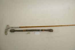 A Malacca riding crop with bound shaft and white metal handle, 27½" long, together with an early