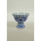 A Chinese blue and white porcelain stem cup with scrolling floral decoration, seal mark to base, 3½"