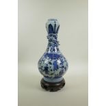 A Chinese blue and white porcelain garlic head shaped vase decorated with figures in a landscape and