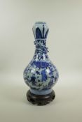 A Chinese blue and white porcelain garlic head shaped vase decorated with figures in a landscape and