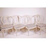 A set of four Scandinavian style chairs, with pierced splats and oval backs, serpentine shaped front