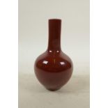 A Chinese sang de boeuf glazed porcelain bottle vase, seal mark to base, 6" high