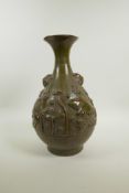 A Chinese olive and brown glazed pottery pear shaped vase with raised carp and lotus flower