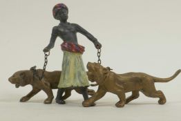 A cold painted bronze figure of an Arab gentleman with two tigers on leads, 3" high