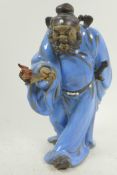 A Chinese, Shiwan style, mud men figure of a warrior with a bat, 12" high