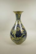 A Chinese blue and white pottery pear shaped vase decorated with figures in a landscape, 18" high,