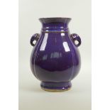 A Chinese amethyst flambe glazed pottery vase with two elephant mask handles, impressed seal mark to