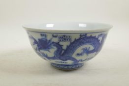 A Chinese blue and white porcelain bowl decorated with two dragons and the flaming pearl, 6