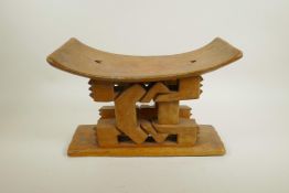 An African carved hardwood tribal stool, 14" wide