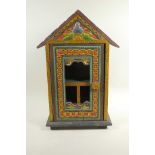An Indian carved and painted hanging cabinet with a glazed door, 19½" high x 13" wide
