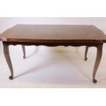 A French oak drawleaf dining table, with parquetry veneered top and pull out leaves, raised on