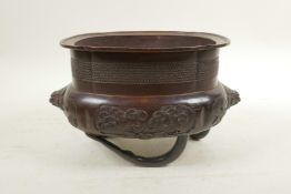 A Japanese bronze censer raised on tripod supports moulded in the form of bamboo, with cypress