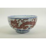 A Chinese blue and white porcelain bowl of lobed form, decorated with iron red dragons to exterior