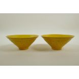 A pair of Chinese yellow ground porcelain conical bowls with raised dragon decoration, seal mark