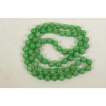 A pale green jade bead necklace, 33" long