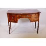 A Georgian inlaid mahogany bowfronted sideboard, with single drawer flanked by a cupboard and deep