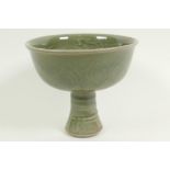 A Chinese green celadon glazed porcelain stem cup, with leaf and dragon decoration, 5" high