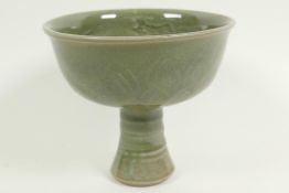 A Chinese green celadon glazed porcelain stem cup, with leaf and dragon decoration, 5" high