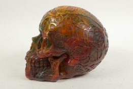 A resin skull moulded with mystic symbols, 5½" high