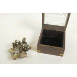 A brass miniature sextant in a hardwood box, the glass lid marked 'Victorian travelling sextant with