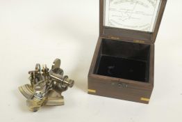 A brass miniature sextant in a hardwood box, the glass lid marked 'Victorian travelling sextant with