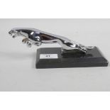 A chrome plated Jaguar car mascot mounted on a marble stand, 7½" long