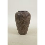 An Oriental carved hardwood money box jar and slot top cover, decorated with a trailing grapevine,