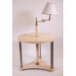 A lacquered centre table with adjustable standard lamp, raised on steel supports with brass