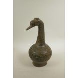 A Chinese bronze vessel, the neck in the form of a phoenix, the body with raised archaic decoration,
