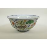 A Chinese wucai porcelain bowl of lobed form decorated with carp in a lotus pond, 6 character mark