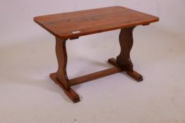 An ash refectory style coffee table on shaped end supports, 17½" x 27½" x 17¼"