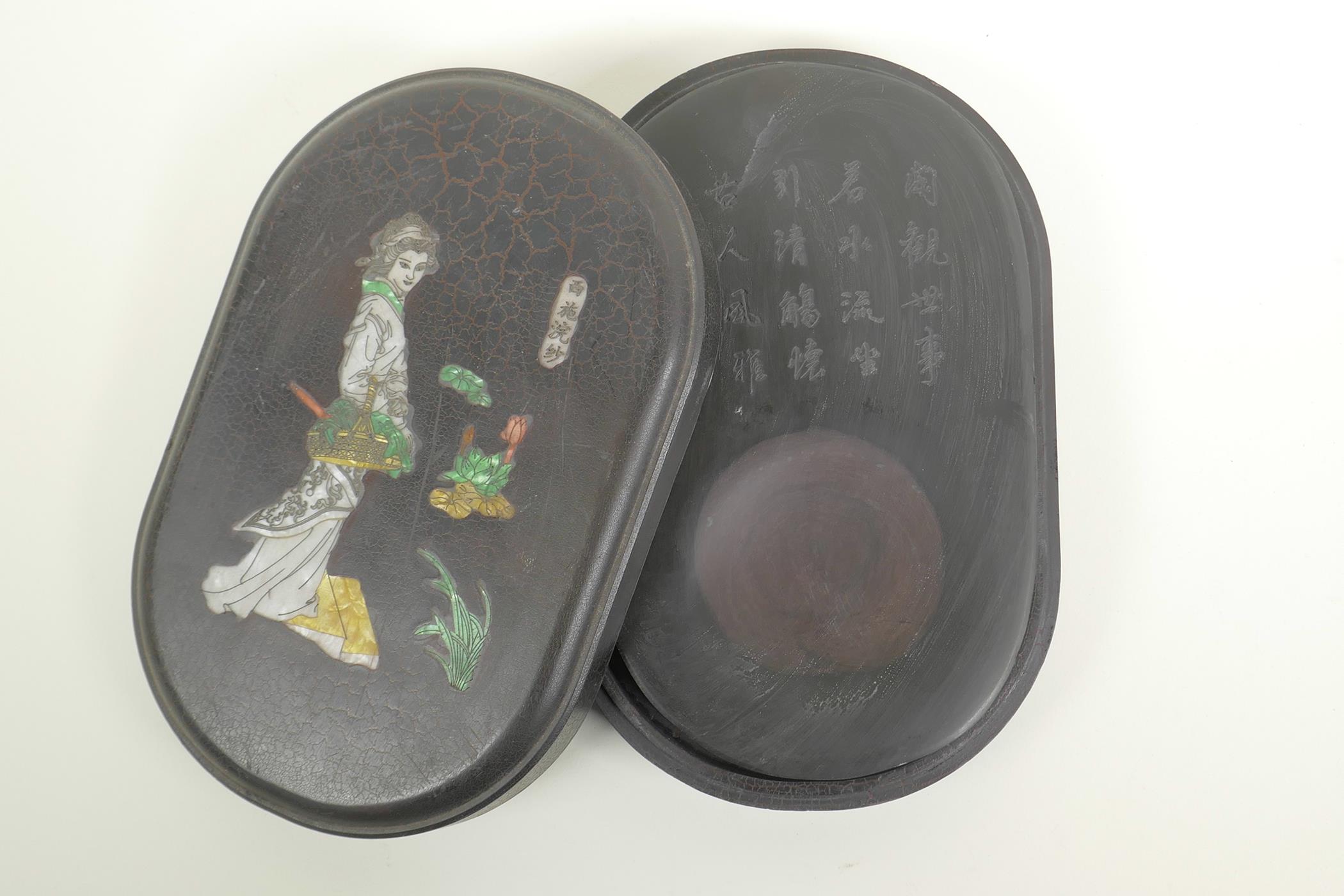 A Chinese boxed inkstone with an engraved inscription, the cover with inset figural decoration,