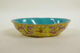A Chinese polychrome porcelain shaped bowl with blue and pink enamelled dragon decoration on a