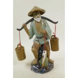 A large Chinese, Shiwan style, mud men figure of a fisherman with his baskets and catch, 11½" high
